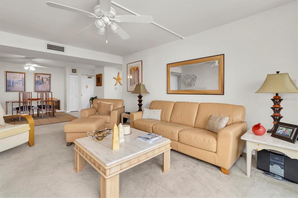 1 Key Capri, Unit 502E Treasure Island, FL 33706 - Photo 12 of 51 a living room with furniture and a chandelier