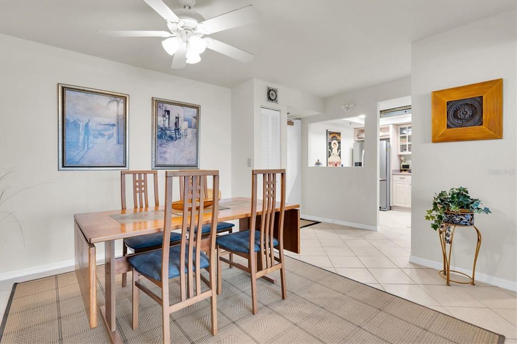 1 Key Capri, Unit 502E Treasure Island, FL 33706 - Photo 15 of 51 a view of a dining room with furniture and a potted plant