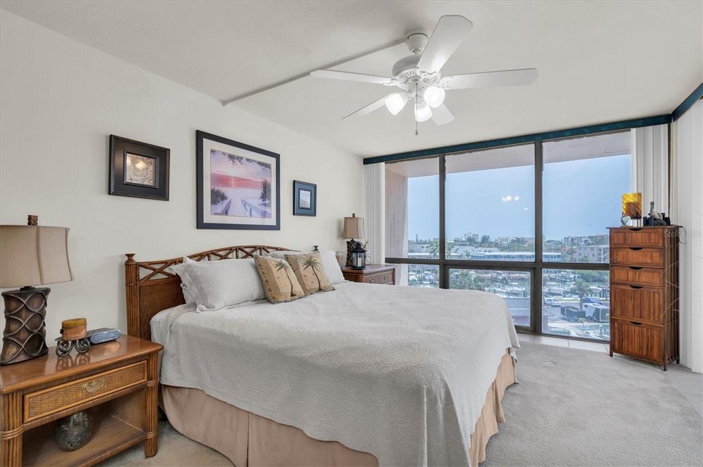 1 Key Capri, Unit 502E Treasure Island, FL 33706 - Photo 18 of 51 a bed room with a bed and a chandelier