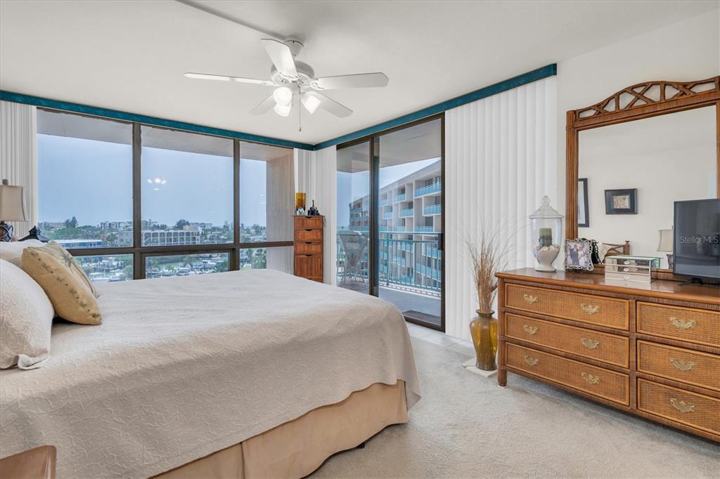 1 Key Capri, Unit 502E Treasure Island, FL 33706 - Photo 19 of 51 a spacious bedroom with a large bed and a large window