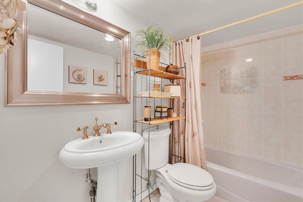 1 Key Capri, Unit 502E Treasure Island, FL 33706 - Photo 24 of 51 a bathroom with a sink toilet and shower