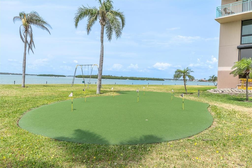 1 Key Capri, Unit 502E Treasure Island, FL 33706 - Photo 36 of 51 a view of a swimming pool with a yard