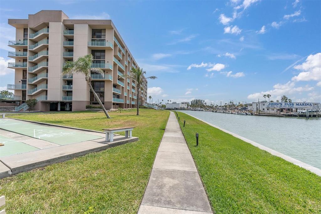 1 Key Capri, Unit 502E Treasure Island, FL 33706 - Photo 38 of 51 a view of swimming pool with a yard
