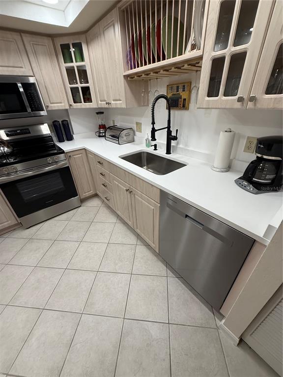 1 Key Capri, Unit 502E Treasure Island, FL 33706 - Photo 6 of 51 a kitchen with a sink and cabinets
