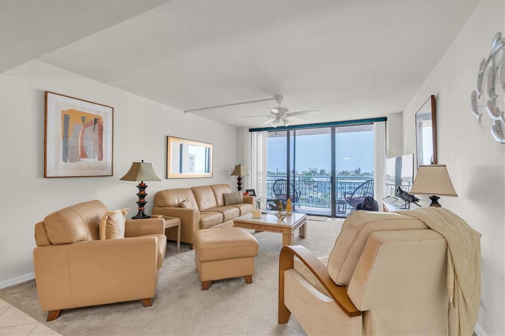 1 Key Capri, Unit 502E Treasure Island, FL 33706 - Photo 10 of 51 a living room with furniture and large windows