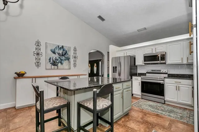 a view of a house with yard and a garden