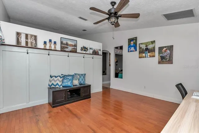 a view of a hallway with entryway wooden floor and front door