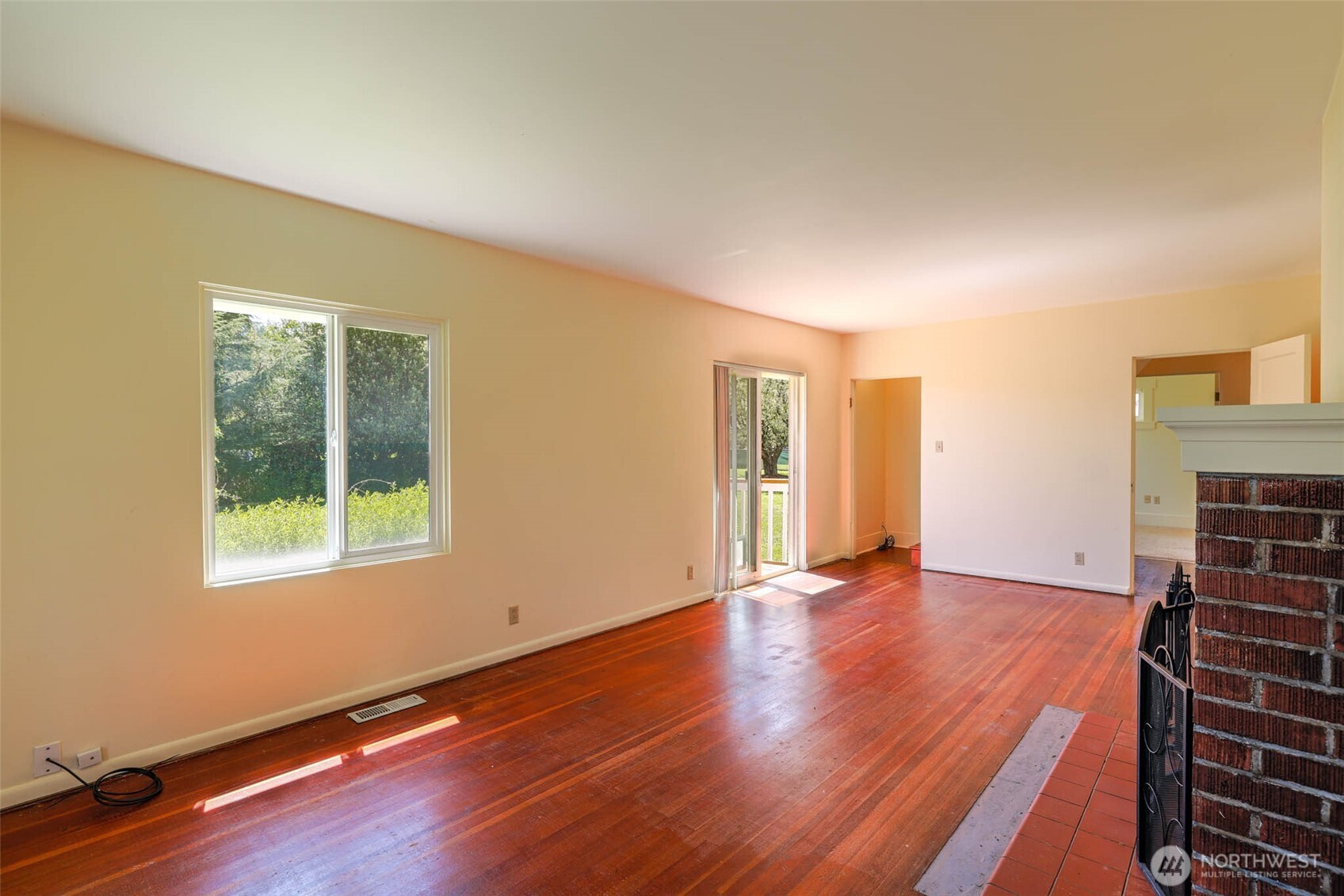 1320 4th Street Cosmopolis, WA 98537 - Photo 10 of 40 a view of an empty room with wooden floor and a window