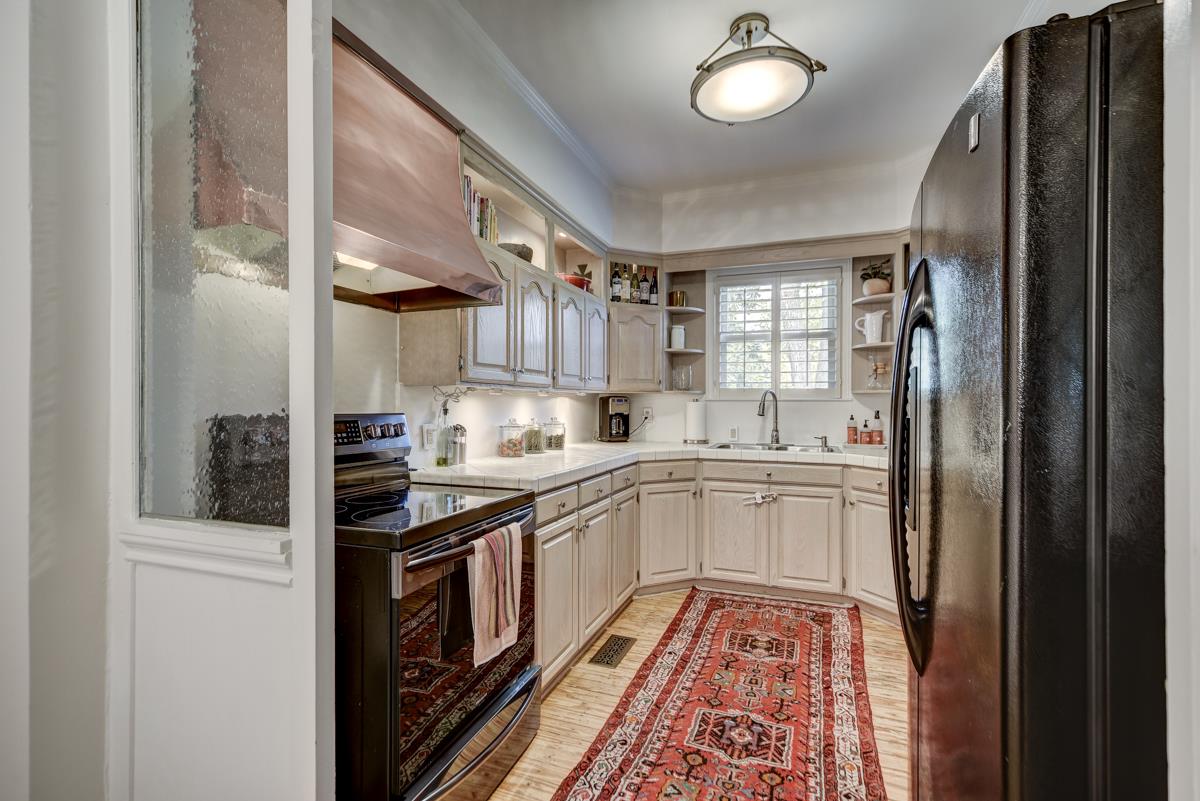 1132 Winding Way Road Nashville, TN 37216 - Photo 12 of 30 High functioning kitchen has been enjoyed most recently by an avid cook and includes a copper vent hood, pull-out drawers, custom cabinetry, and under cabinet lighting.