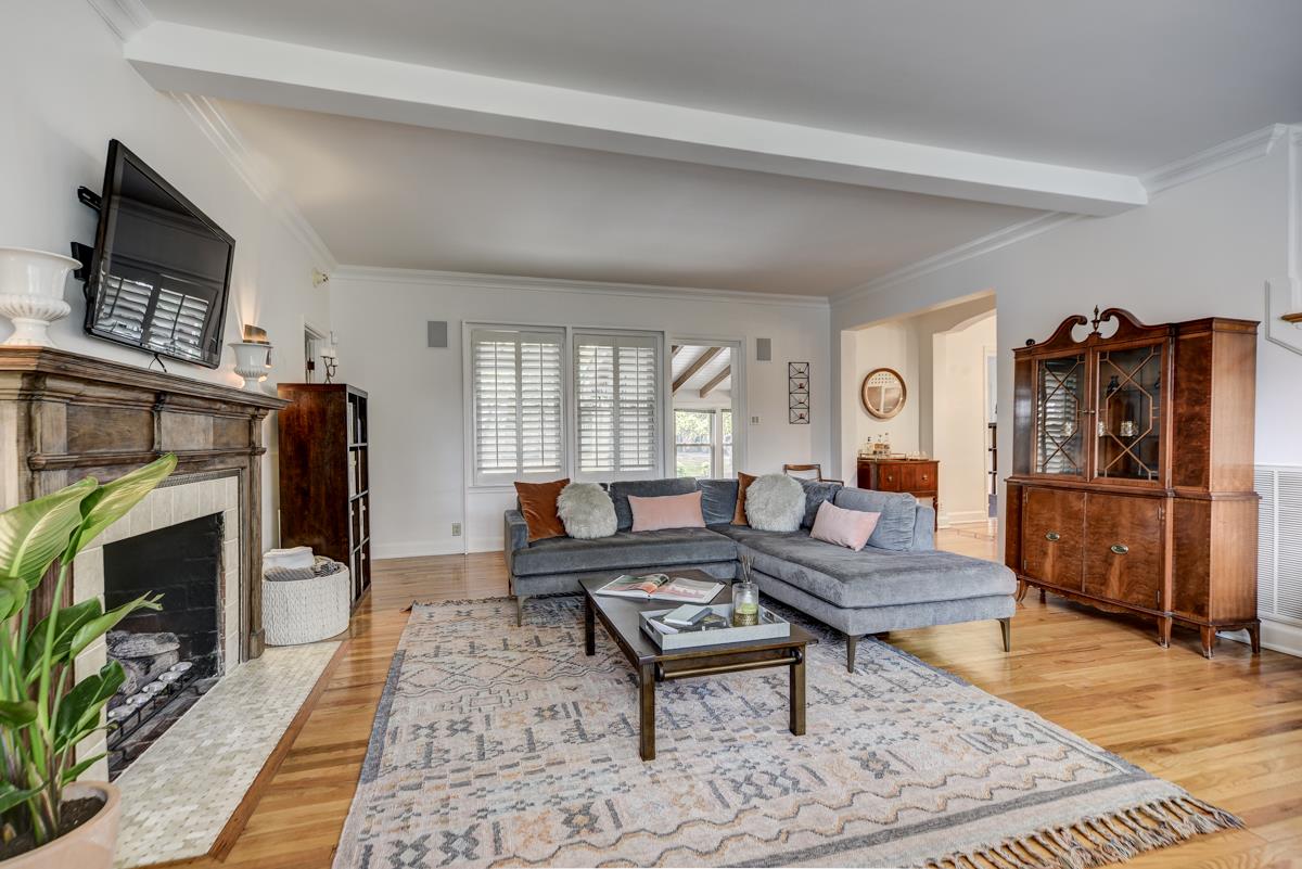 Living room includes a gas fireplace (could also accommodate wood burning) and lots of windows.