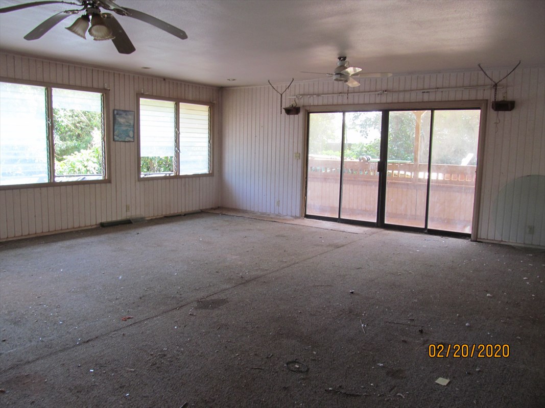 4912 Ohu Road Kapaa, HI 96746 - Photo 7 of 9 an empty room with windows and chandelier