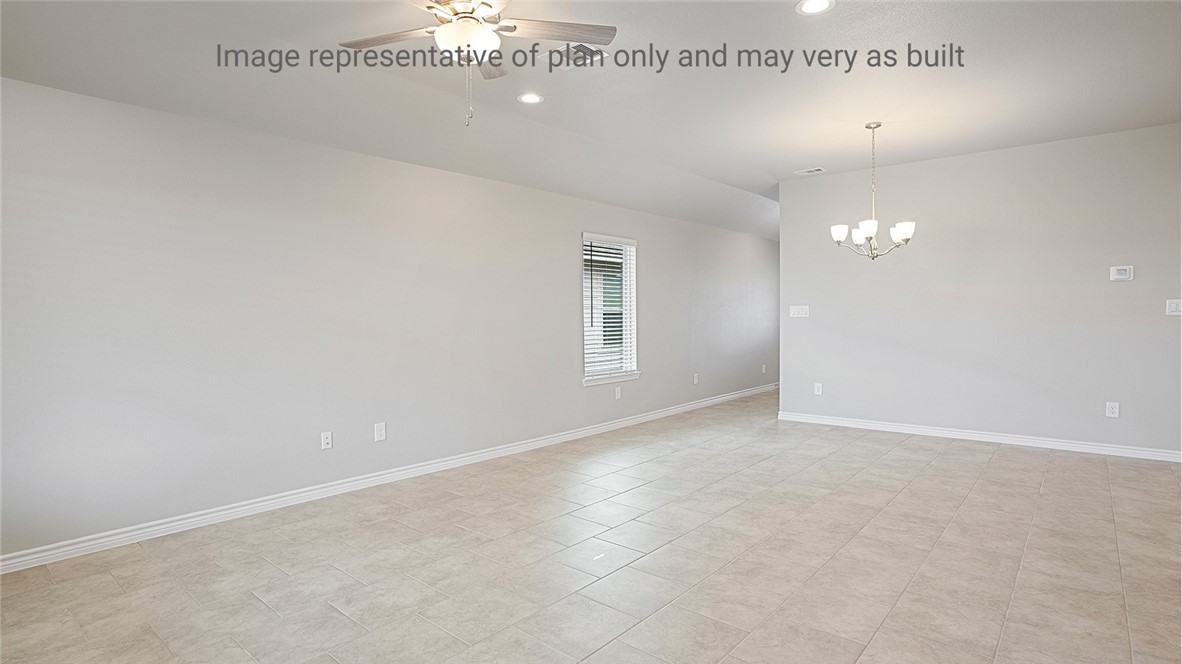 1411 Choctaw Road Sinton, TX 78387 - Photo 3 of 28 an empty room with a chandelier fan and windows