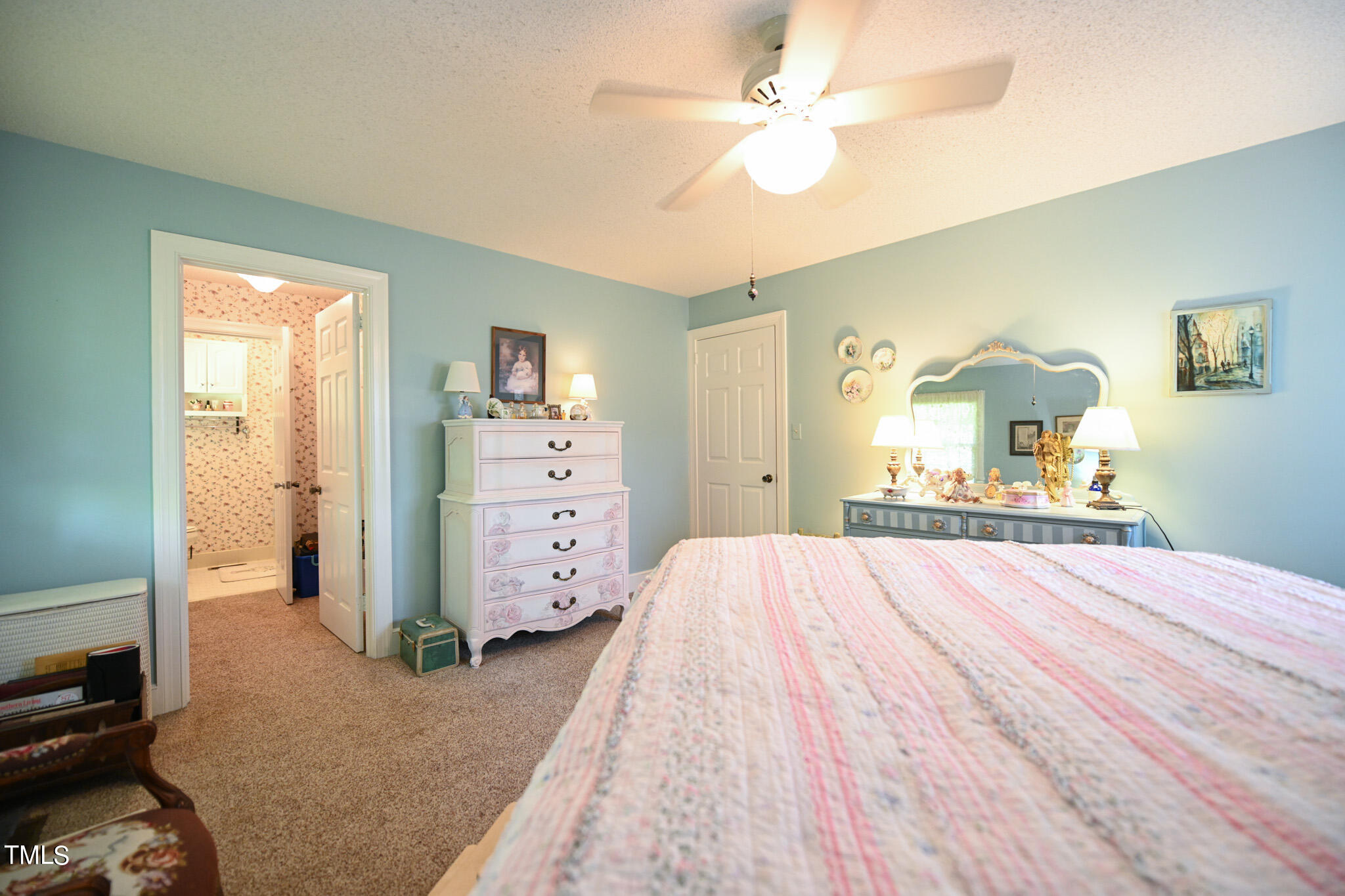 7254 Springfield School Road Lucama, NC 27851 - Photo 31 of 54 a bedroom with a bed and a chandelier