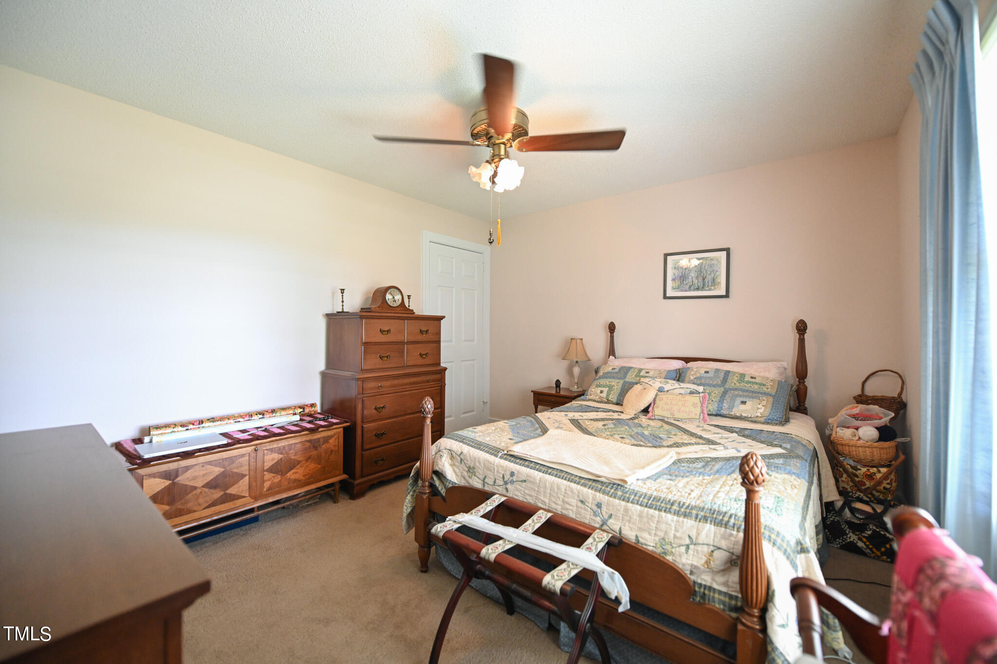 7254 Springfield School Road Lucama, NC 27851 - Photo 42 of 54 a bedroom with a bed and a chandelier