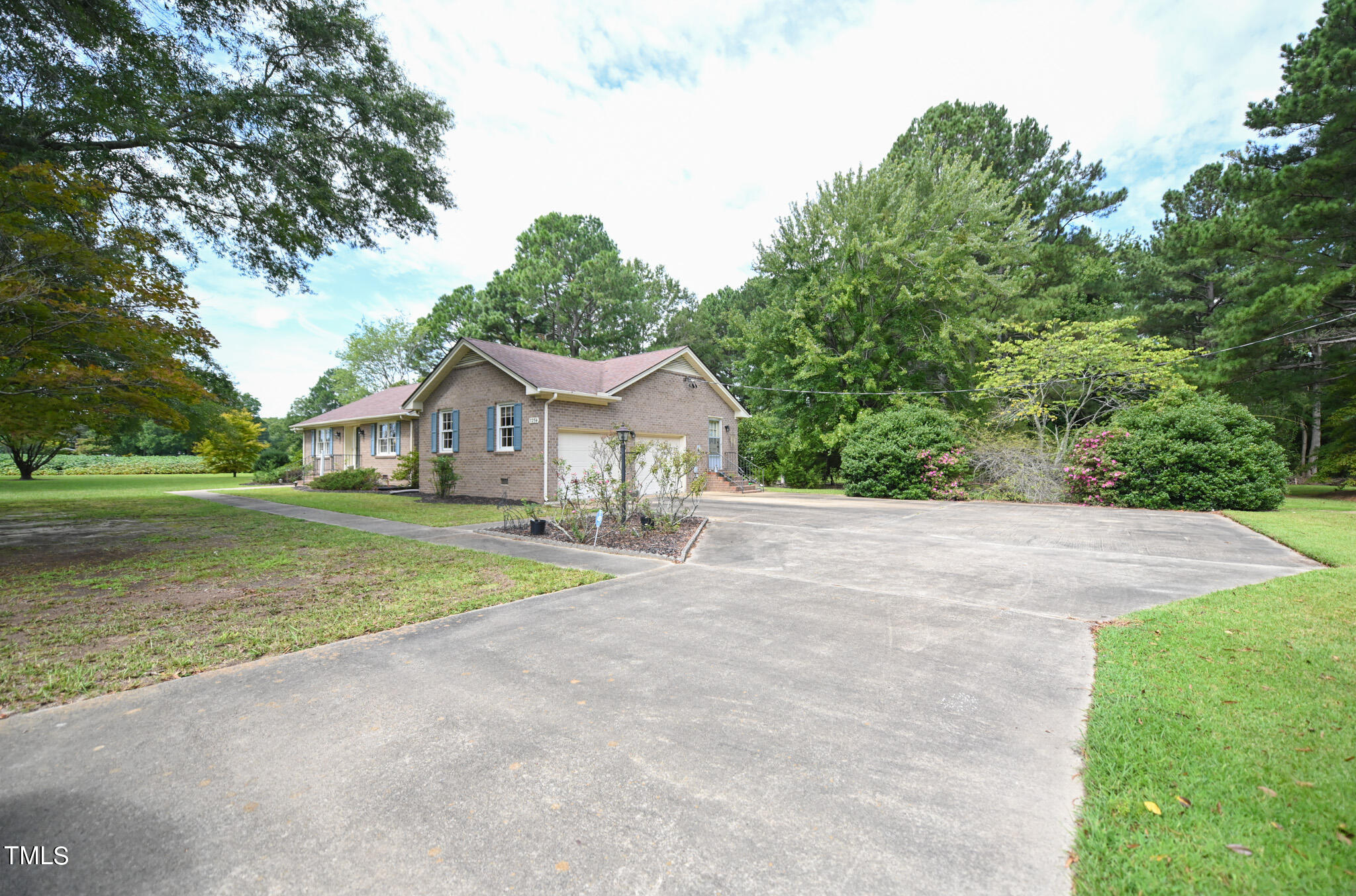 7254 Springfield School Road Lucama, NC 27851 - Photo 5 of 54 a front view of a house with a yard and garage