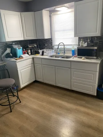 a kitchen with sink cabinets and window