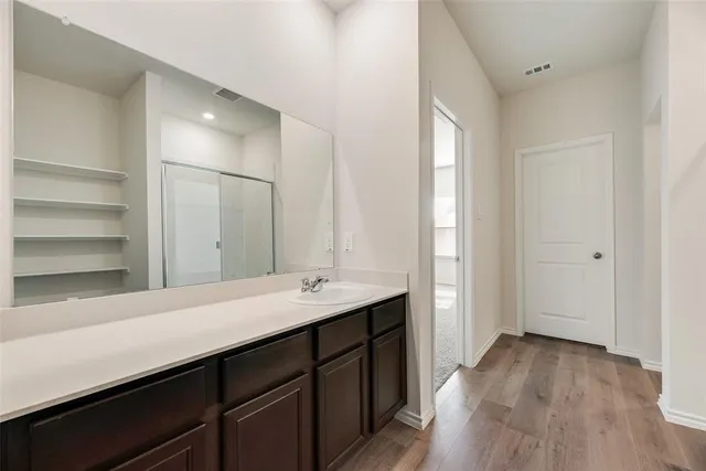 a en suite bathroom with a sink double vanity and a mirror