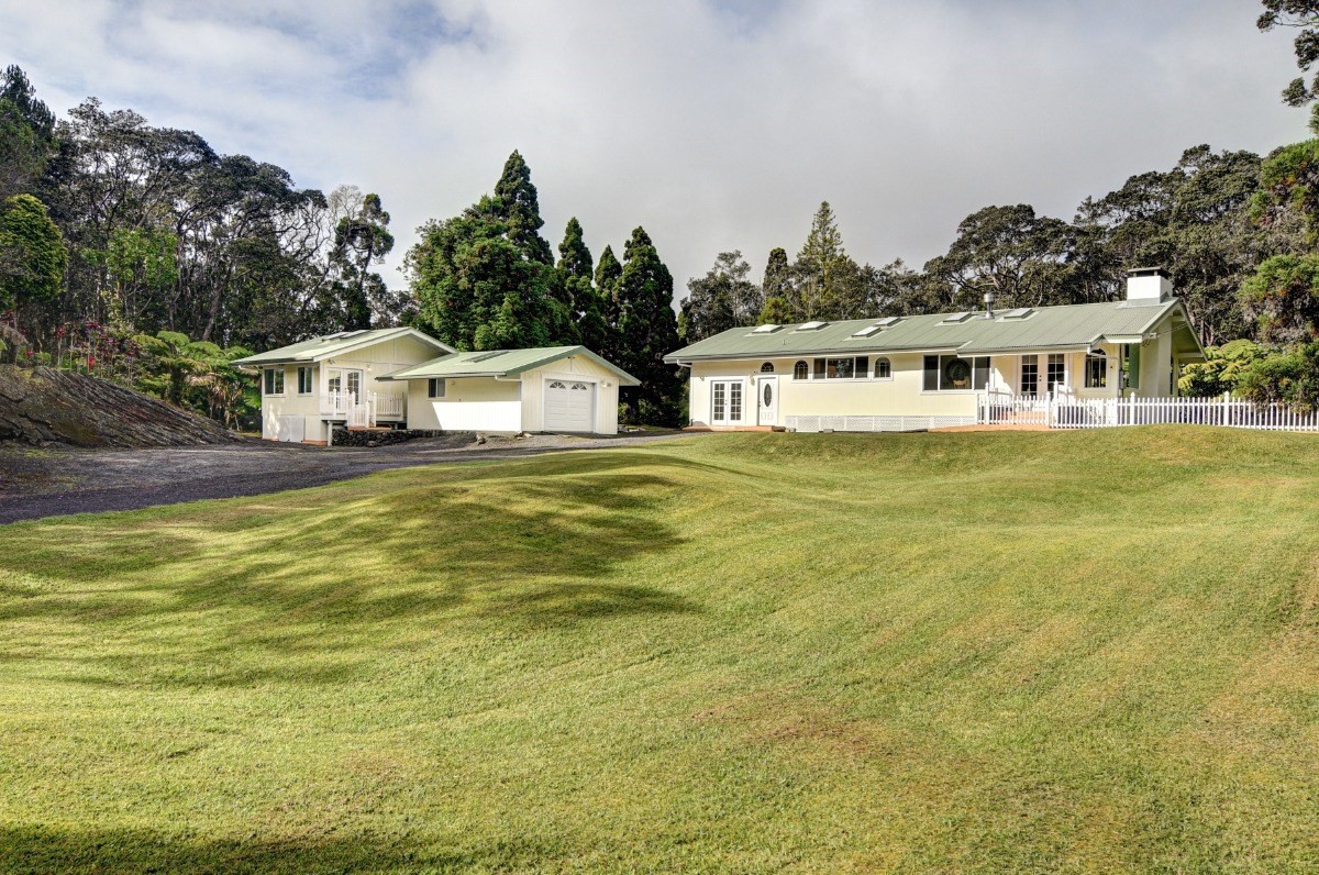 19-4089 Wright Road Volcano, HI 96785 - Photo 1 of 30 a front view of a house with a garden