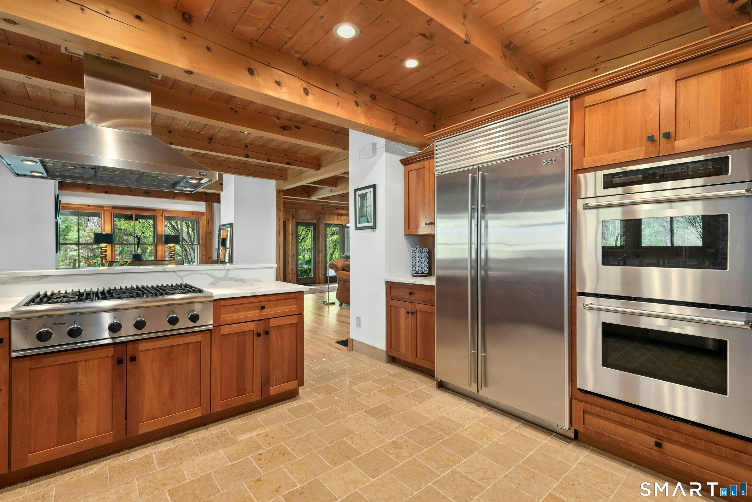 15 Silversmith Lane Redding, CT 06896 - Photo 13 of 36 Chef's kitchen. Sub Zero, Thermador appliances, limestone flooring, quartz counters, breakfast bar, cherry cabinetry and lots of well-designed storage.
