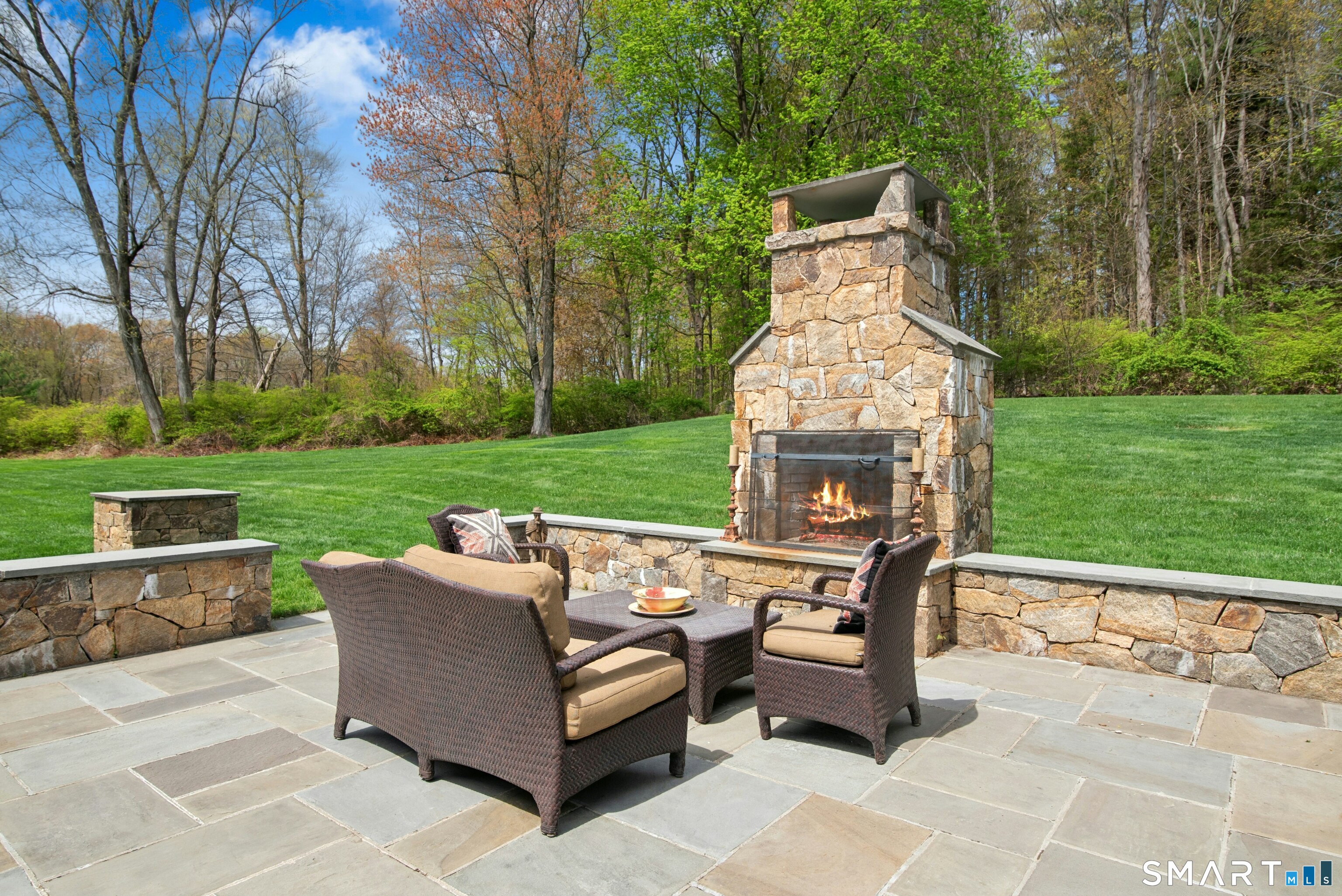 15 Silversmith Lane Redding, CT 06896 - Photo 30 of 36 Expansive stone patio with wood-burning fireplace, a joy in every season. There's a gas grill and table and chairs-perfect for BBQ's and al fresco dining.