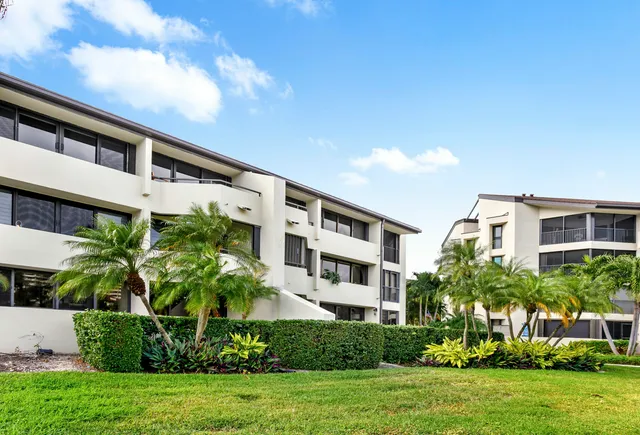 a front view of a building with a garden
