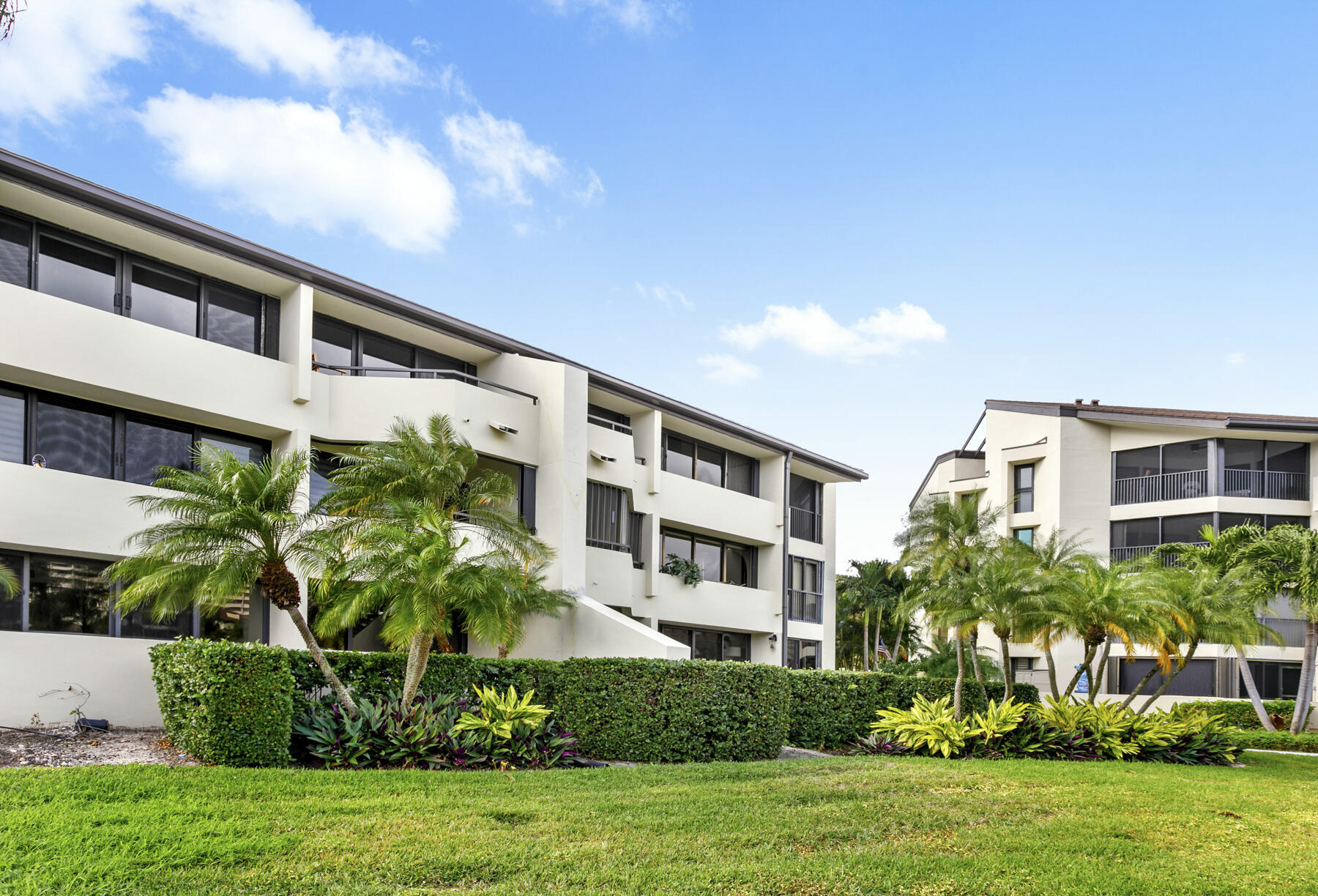 a front view of a building with a garden