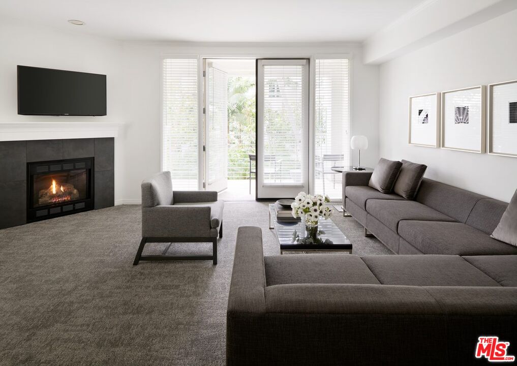 155 North Crescent Drive, Unit 1BRPR Beverly Hills, CA 90210 - Photo 3 of 10 a living room with furniture and a fireplace