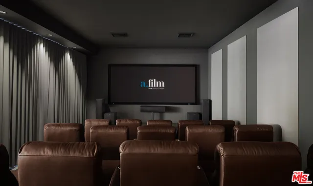 a projector room with a couch and a flat screen tv