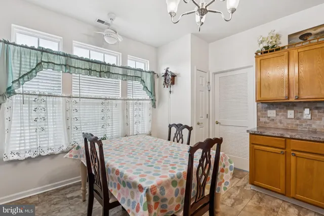 a dining room with furniture and window