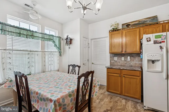 a kitchen with stainless steel appliances granite countertop a sink and a refrigerator