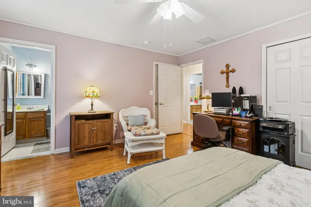 a bedroom with furniture and a wooden floor