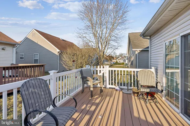 a view of a wooden deck with chairs
