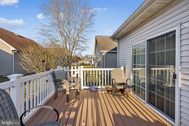a view of balcony with wooden floor and fence