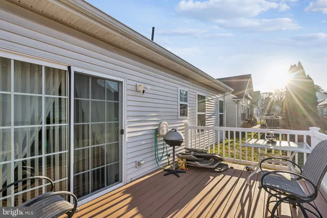 a view of a deck with table and chairs and wooden floor