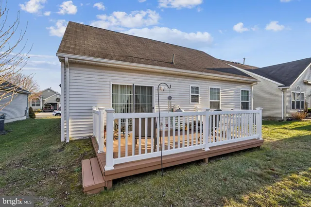 a view of a house with a yard and deck