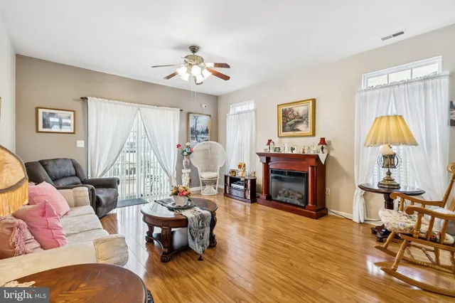 a living room with furniture a fireplace and a window