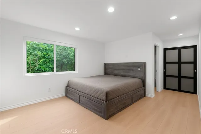 a bedroom with a bed and a window