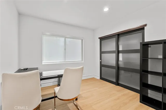 a view of a room with furniture and wooden floor