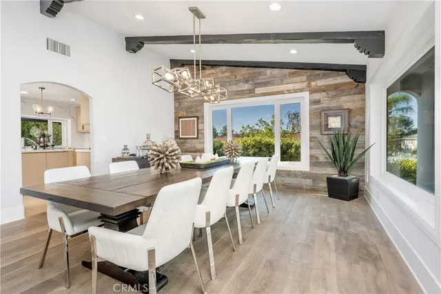 a view of a dining room with furniture wooden floor and chandelier