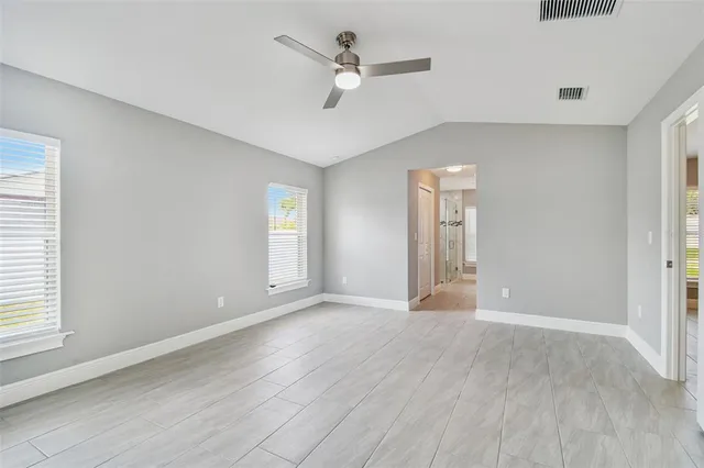 a spacious bathroom with a double vanity sink a mirror and a window