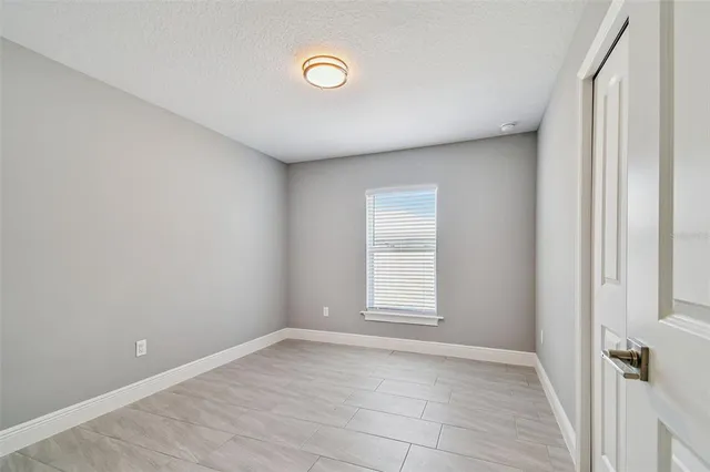 a view of a livingroom with wooden floor and a large window