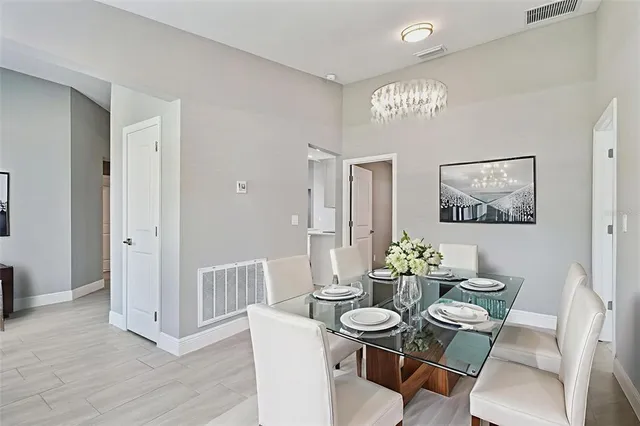 a spacious bedroom with a bed and a flat screen tv