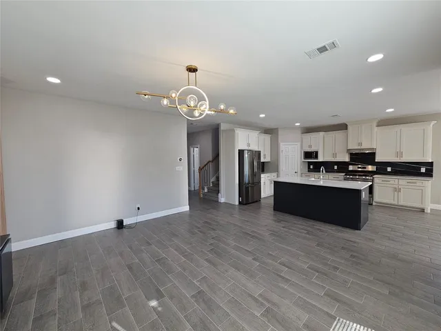 a view of kitchen with cabinets and stainless steel appliances