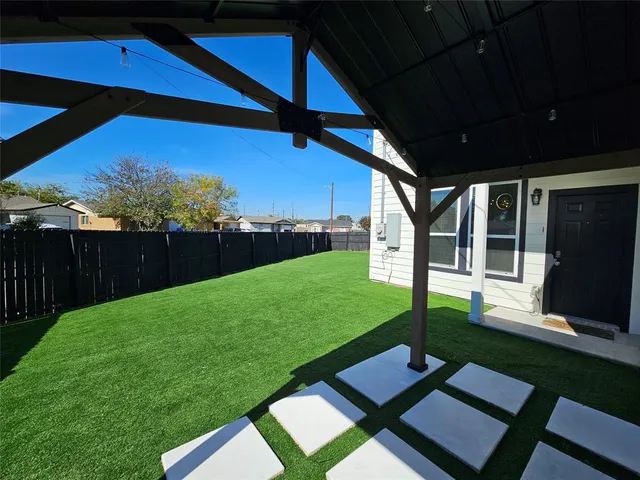 a view of a backyard with sitting area
