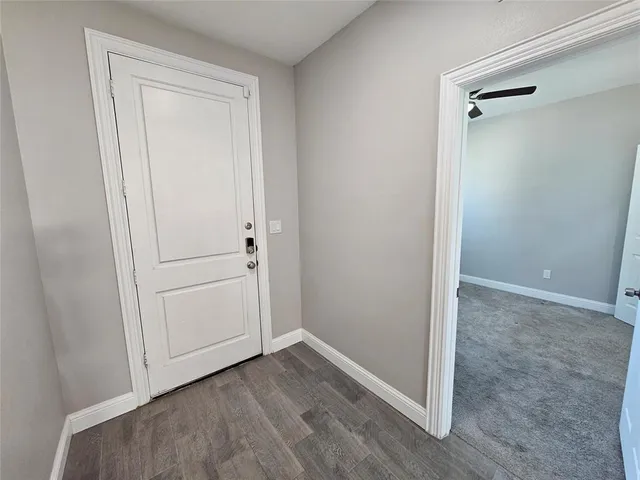 an empty room with wooden floor