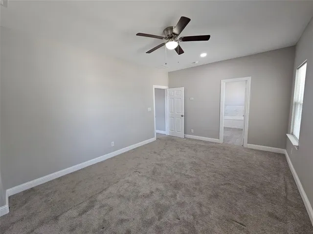 an empty room with closet and windows