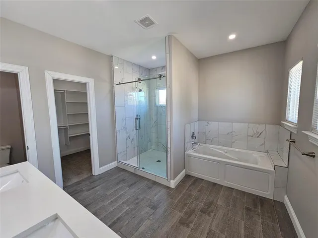 a bathroom with a bathtub and a shower
