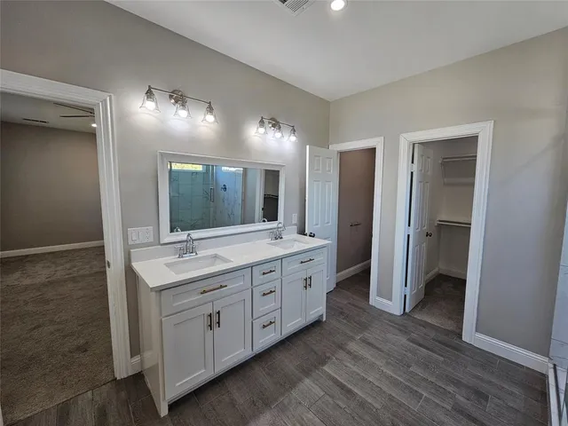 a spacious bathroom with a double vanity sink double and mirror