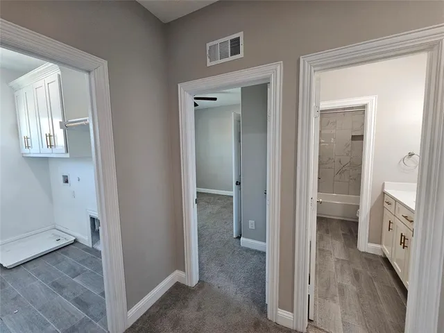 a view of a hallway with closet and wooden floor