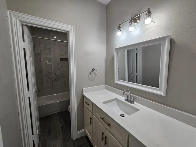 a white bath tub sitting next to a white toilet